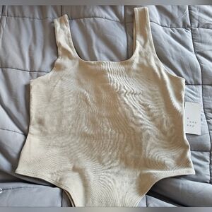 A New Day, Tan Thong Body Suit.